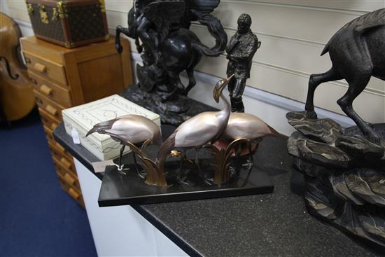 Armand Sinko. A French Art Deco patinated and cold painted bronze figure group of three cranes(-)